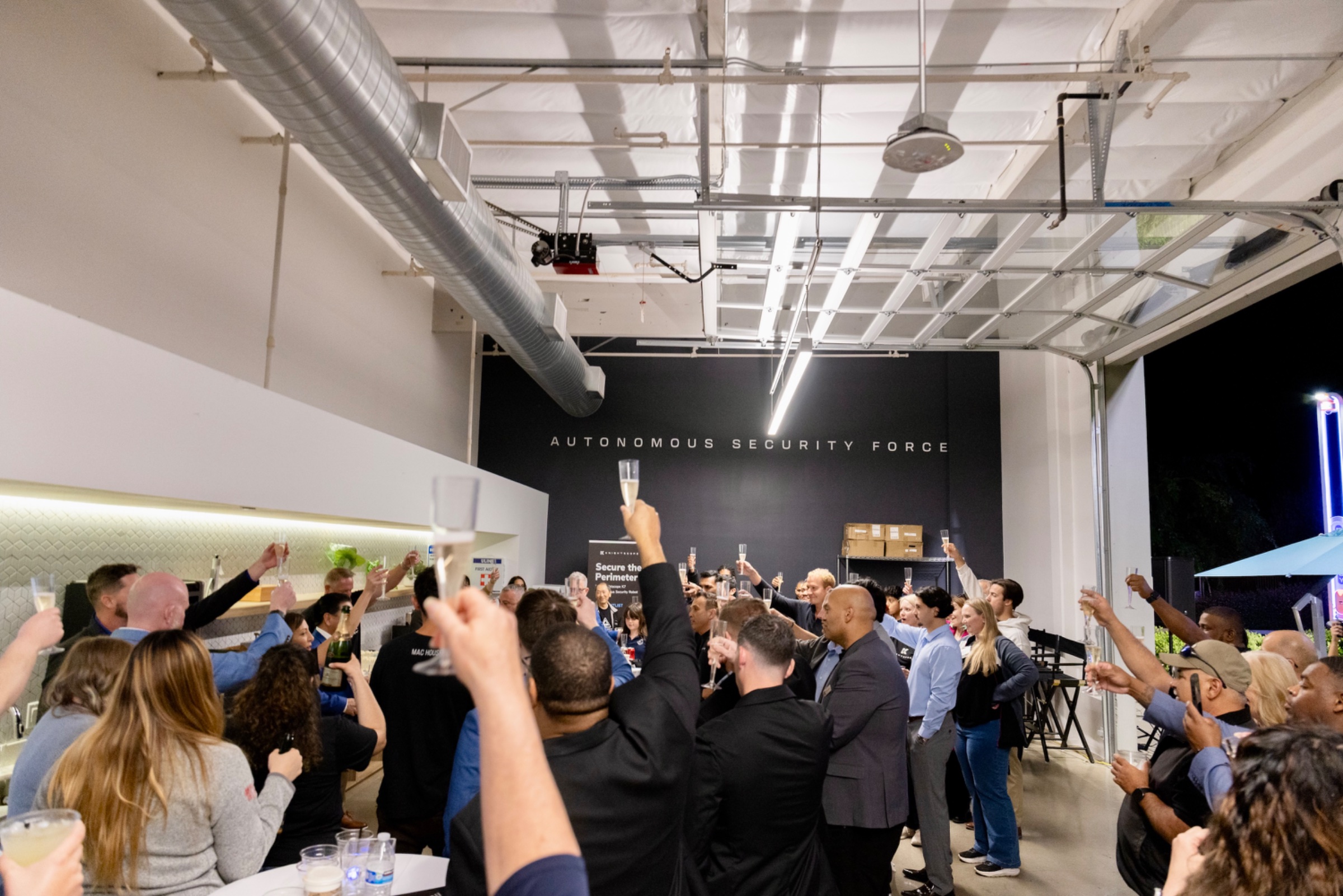 The Knightscope team raising a toast — One Team. One Force.