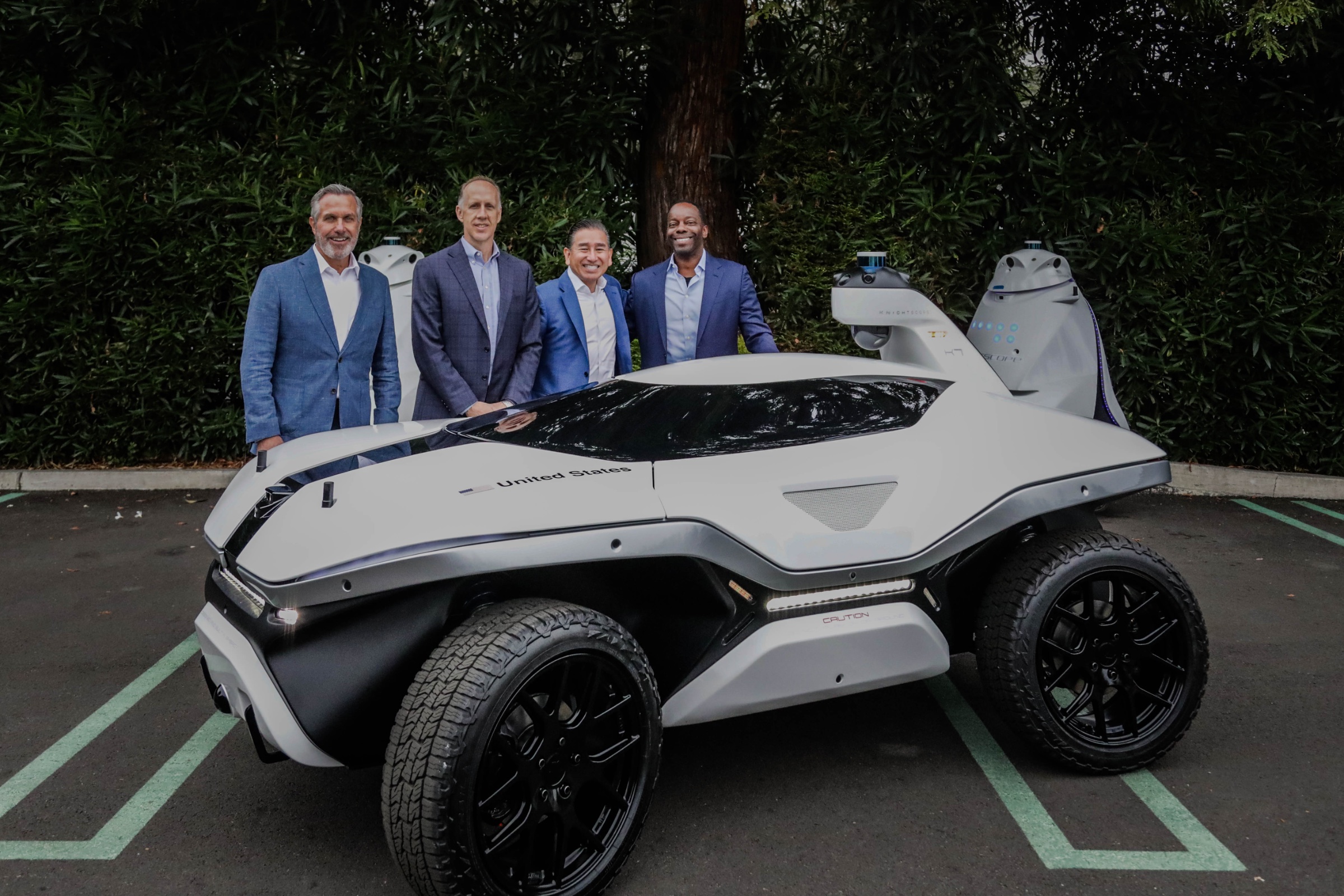 The Knightscope team gathered with a K7 beneath a towering redwood at Silicon Valley headquarters